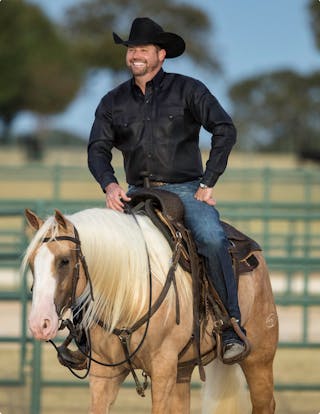 Clinton Anderson smiling on horse